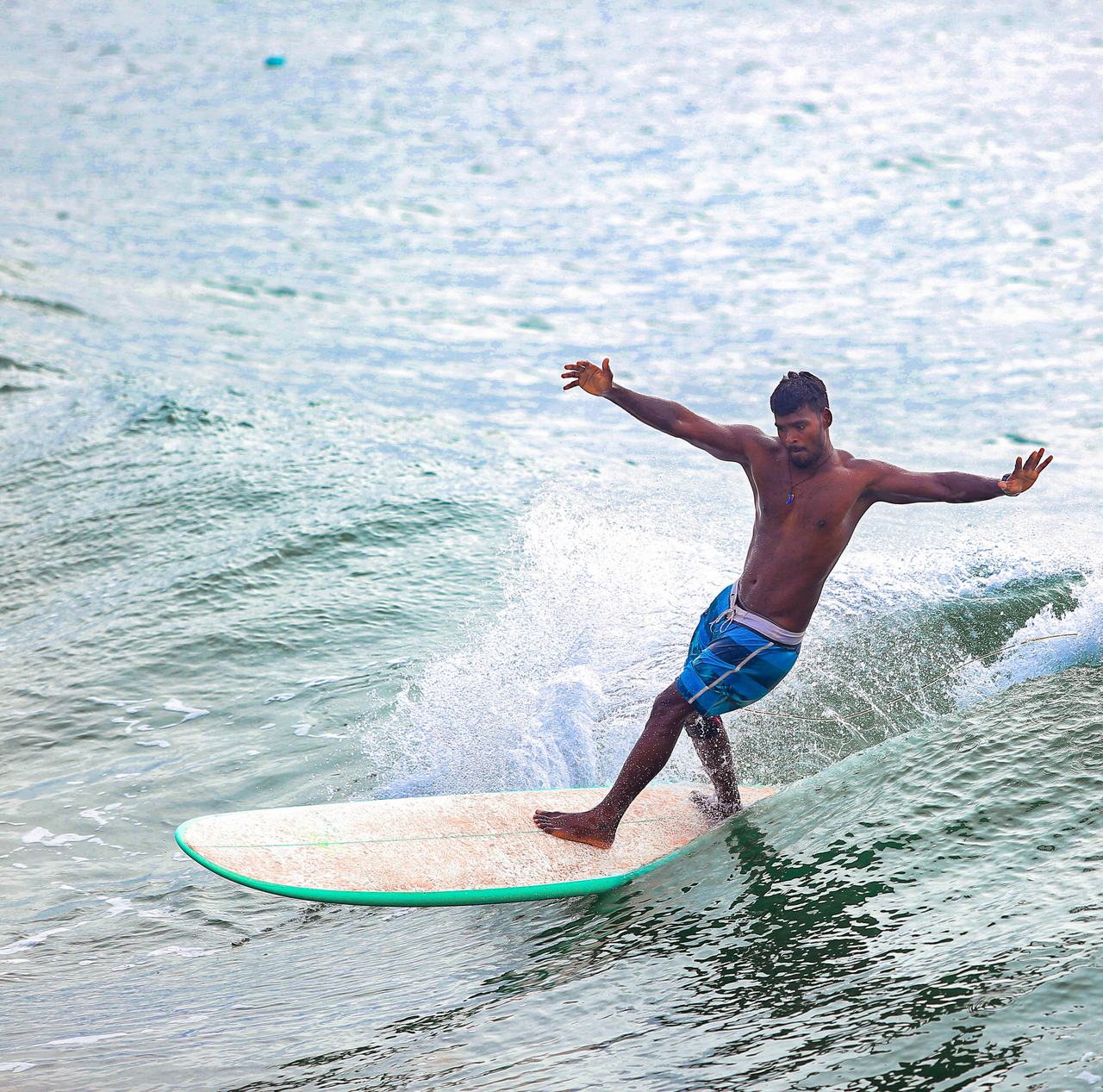 Longboarder cross-stepping on a clean wave