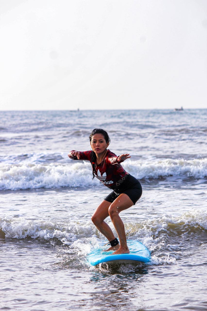 Student riding whitewater towards the shore