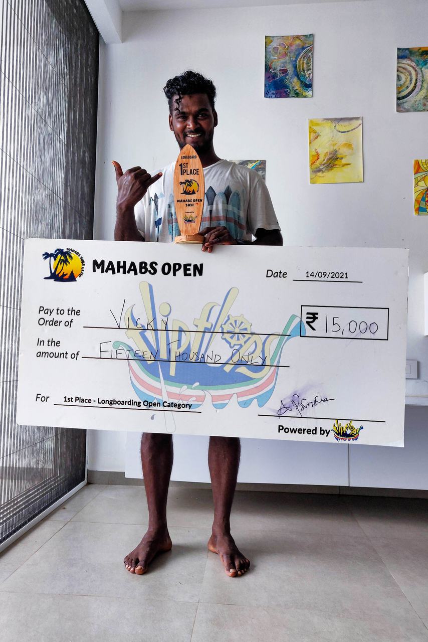 Vicky holding the first-place longboard cheque from the Mahabs Open